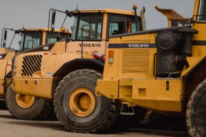 Volvo dump trucks in a lot during a Ritchie Bros heavy equipment auction in Bolton, Ontario, Canada, on Tuesday, May 9, 2023. Ritchie Bros Auctioneers Inc., a Canadian firm that sells heavy equipment at auctions around North America, struck an agreement in November to buy IAA, which sells damaged and written-off vehicles.